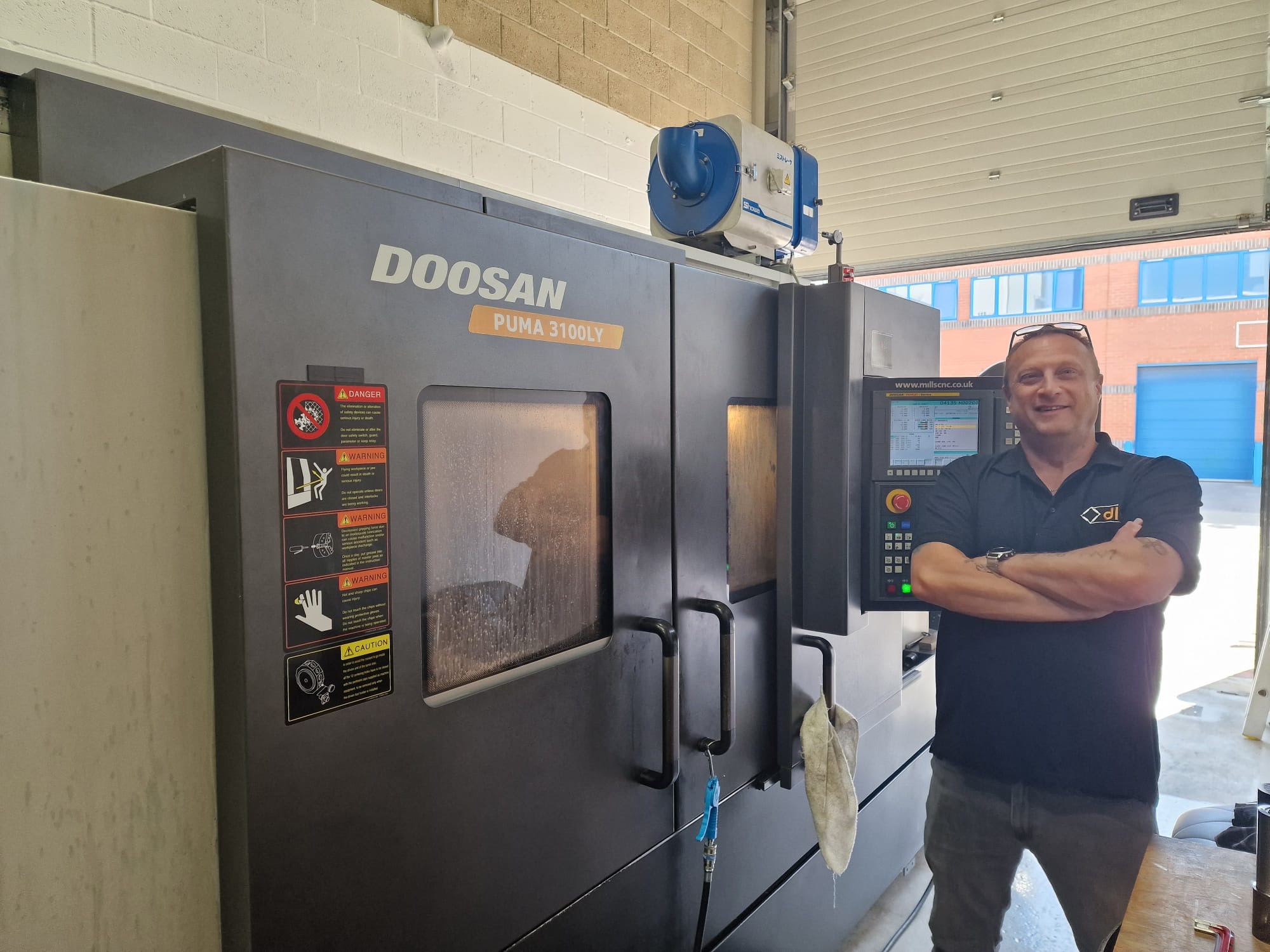 DLM Staff member with new Puma Lathe